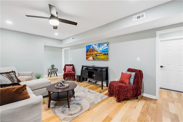 living room featuring hardwood / wood-style flooring and ceiling fan