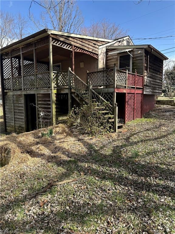 exterior space featuring stairs and a deck