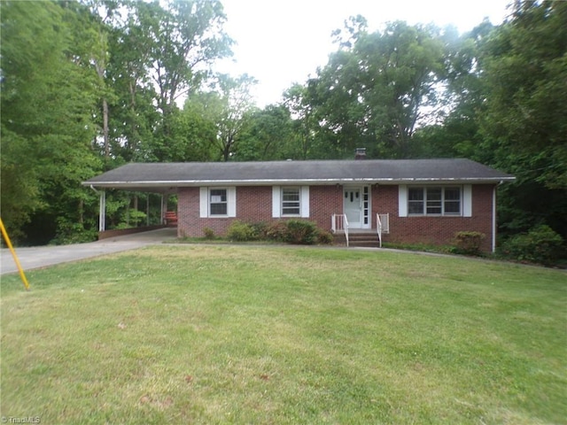 ranch-style home with brick siding, concrete driveway, a front lawn, a carport, and entry steps