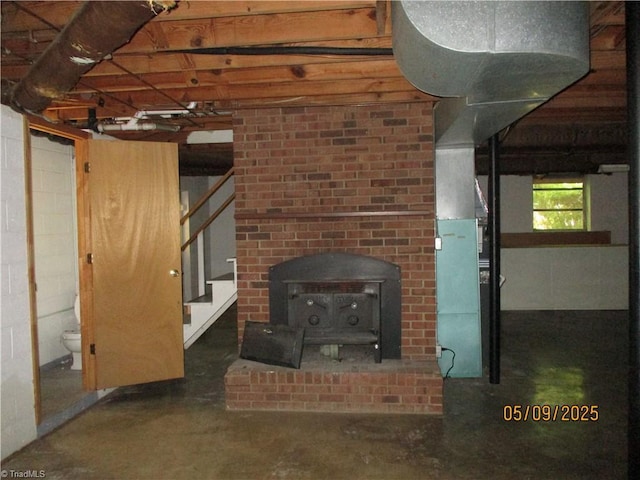 below grade area featuring concrete block wall and stairway