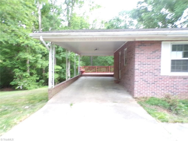 view of parking / parking lot with driveway and a carport