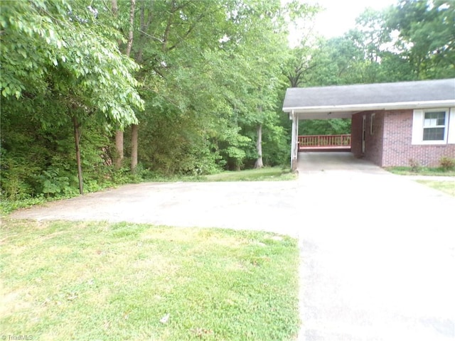 exterior space featuring driveway and an attached carport