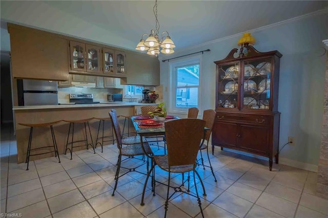 196 Watson Ln, Lexington, NC 27292 - dining area with light tile patterned flooring, a chandelier, and crown molding