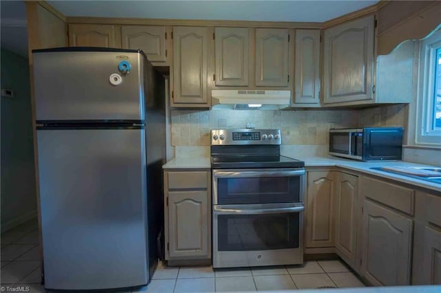 196 Watson Ln, Lexington, NC 27292 - kitchen with stainless steel appliances, under cabinet range hood, light countertops, and light tile patterned flooring