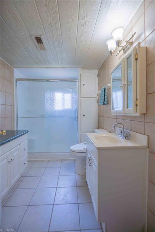 196 Watson Ln, Lexington, NC 27292 - bathroom featuring tile walls, vanity, a stall shower, tile patterned flooring, and wood ceiling