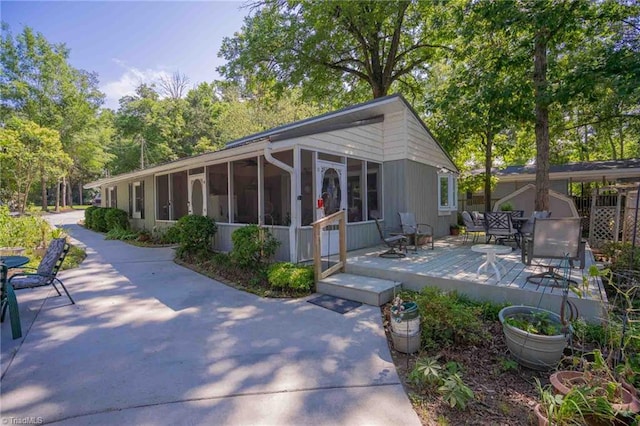 196 Watson Ln, Lexington, NC 27292 - view of front facade with a sunroom, outdoor dining area, and a wooden deck