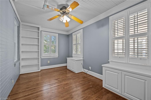 unfurnished bedroom with ceiling fan, crown molding, dark wood-type flooring, and multiple windows