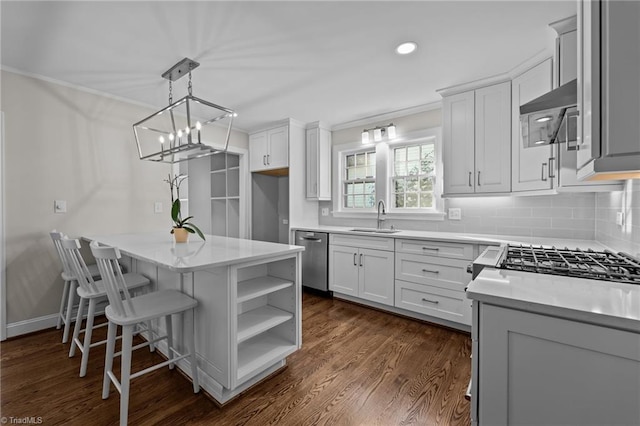 kitchen with white cabinetry, sink, hanging light fixtures, stainless steel dishwasher, and backsplash