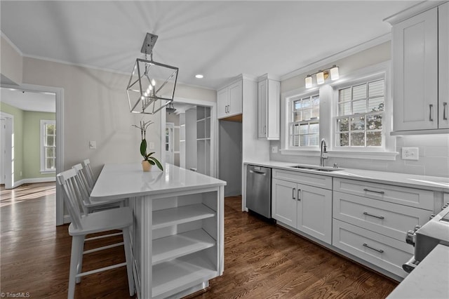 kitchen featuring dishwasher, decorative light fixtures, and white cabinetry