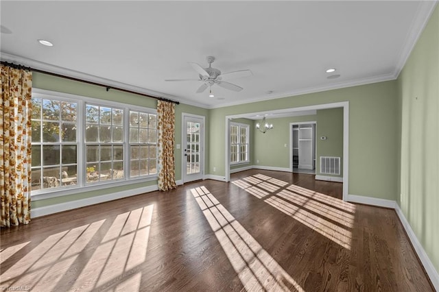 empty room with ceiling fan with notable chandelier, crown molding, and dark wood-type flooring