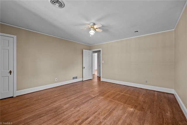 unfurnished room with hardwood / wood-style floors, ceiling fan, and ornamental molding