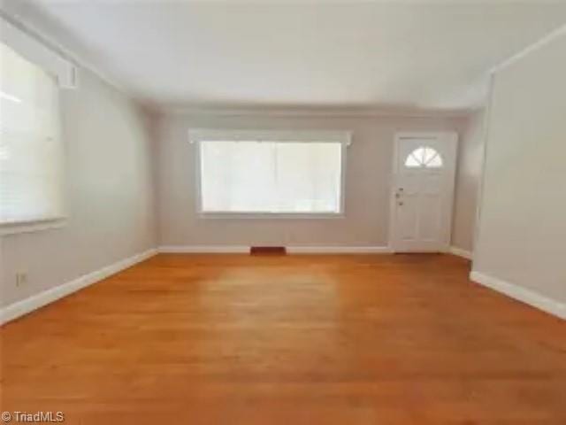 interior space with light wood-type flooring and baseboards