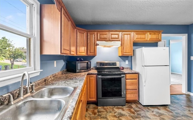 1115 Wachovia St, Winston-Salem, NC 27101 - kitchen with electric range, freestanding refrigerator, a sink, under cabinet range hood, and dark stone finish floors