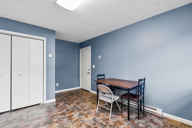 1115 Wachovia St, Winston-Salem, NC 27101 - dining room with stone finish flooring, baseboards, and a textured ceiling