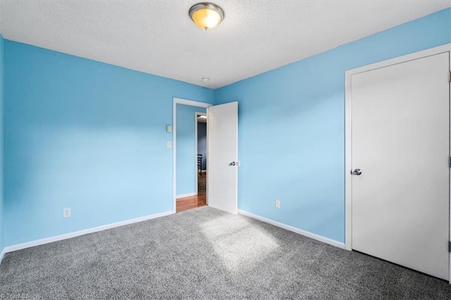 1115 Wachovia St, Winston-Salem, NC 27101 - unfurnished bedroom with carpet, baseboards, and a textured ceiling