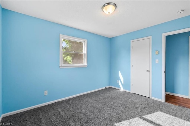 1115 Wachovia St, Winston-Salem, NC 27101 - unfurnished bedroom featuring dark carpet and baseboards