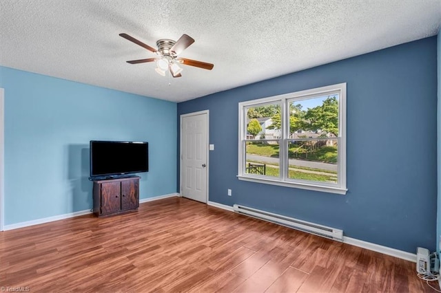 1115 Wachovia St, Winston-Salem, NC 27101 - unfurnished living room with baseboard heating, wood finished floors, ceiling fan, baseboards, and a textured ceiling