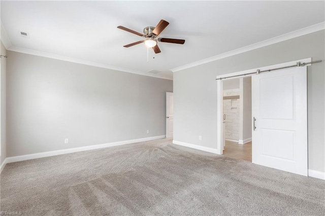 7028 Westfield Village Cir, Summerfield, NC 27358 - unfurnished bedroom with carpet flooring, ornamental molding, ceiling fan, and a barn door