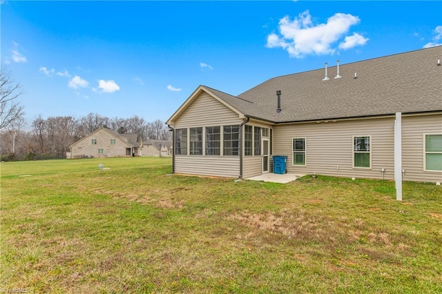 7028 Westfield Village Cir, Summerfield, NC 27358 - rear view of house with a sunroom, a lawn, a patio area, and a shingled roof
