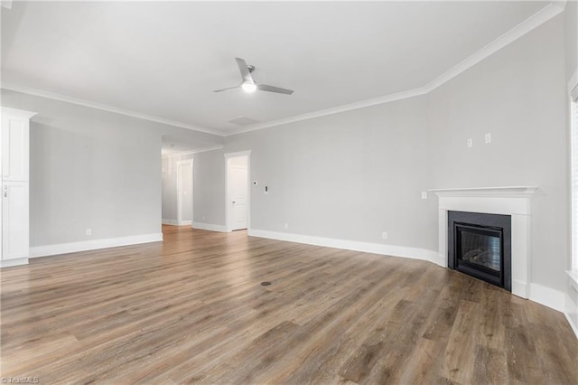 7028 Westfield Village Cir, Summerfield, NC 27358 - unfurnished living room featuring ceiling fan, ornamental molding, a glass covered fireplace, and light wood finished floors