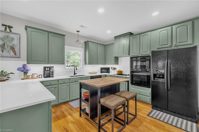 217 Oakmont Park Ct, Kernersville, NC 27284 - kitchen with black appliances, green cabinets, light wood-type flooring, and recessed lighting
