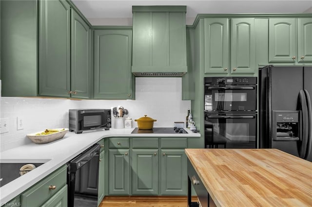 217 Oakmont Park Ct, Kernersville, NC 27284 - kitchen featuring green cabinets, black appliances, premium range hood, butcher block countertops, and backsplash