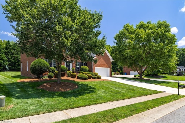 217 Oakmont Park Ct, Kernersville, NC 27284 - view of property hidden behind natural elements featuring brick siding, concrete driveway, and a front yard