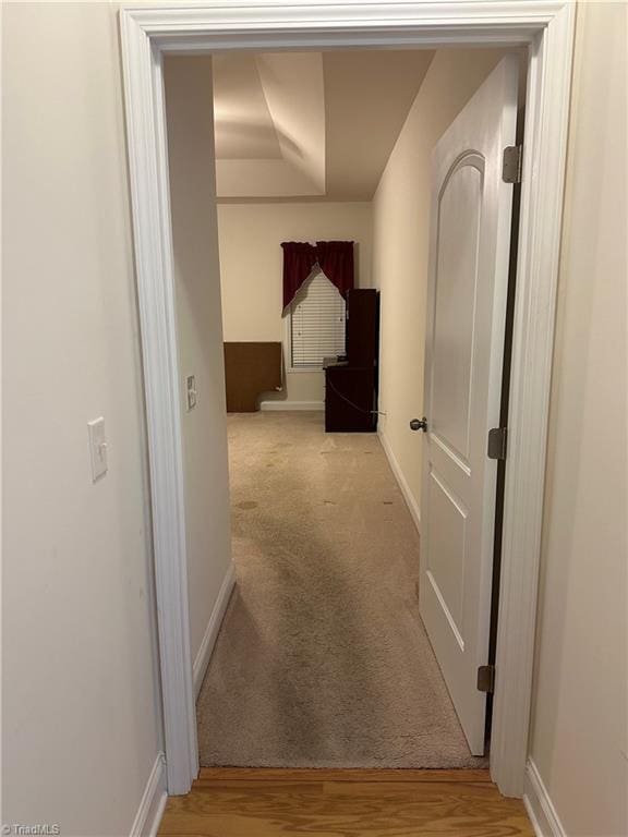 hallway featuring light colored carpet