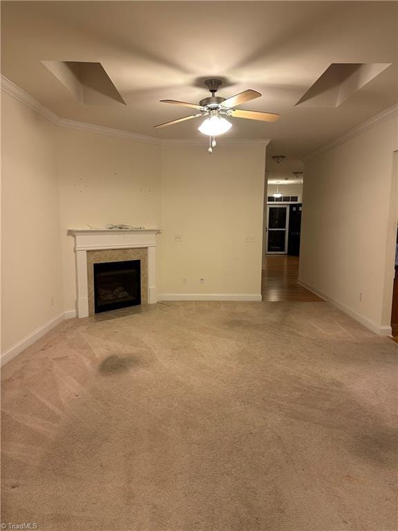 unfurnished living room featuring a tile fireplace, ceiling fan, light carpet, and ornamental molding