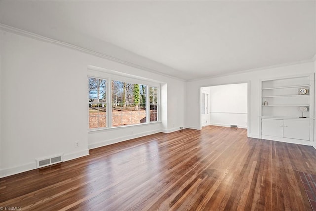 unfurnished living room with dark hardwood / wood-style floors, built in features, and crown molding