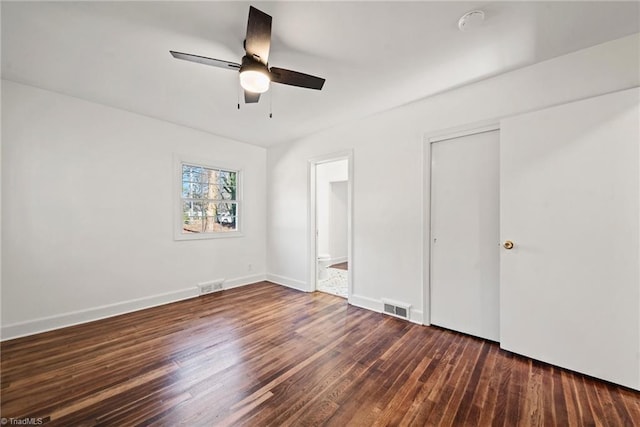 unfurnished bedroom featuring ensuite bath, ceiling fan, and dark hardwood / wood-style flooring