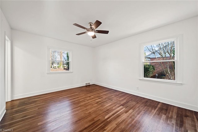 empty room featuring ceiling fan and dark hardwood / wood-style flooring