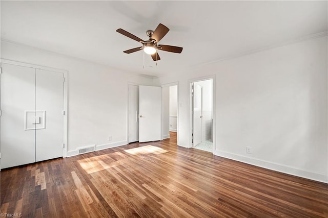 unfurnished bedroom with dark hardwood / wood-style flooring, a closet, ensuite bath, and ceiling fan