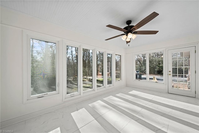 unfurnished sunroom featuring ceiling fan