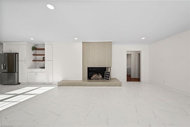 unfurnished living room featuring a brick fireplace