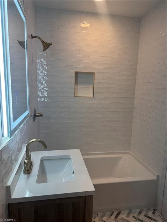 bathroom with vanity and tiled shower / bath