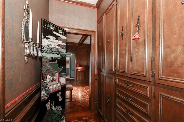 corridor with crown molding and dark parquet flooring