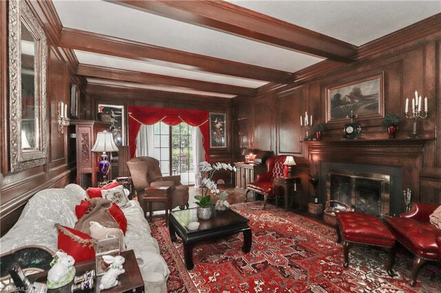 living room with wood walls, ornamental molding, and beam ceiling