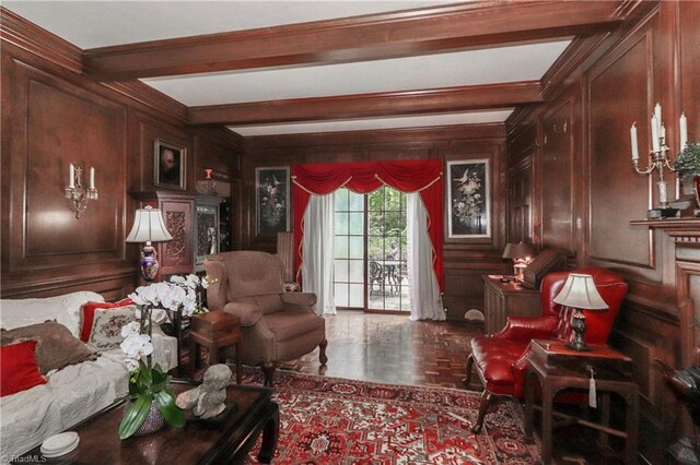 living room with beam ceiling and wooden walls