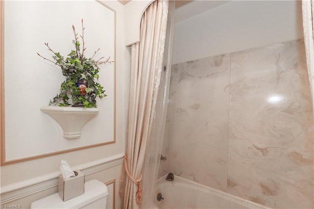 bathroom with toilet and shower / tub combo with curtain