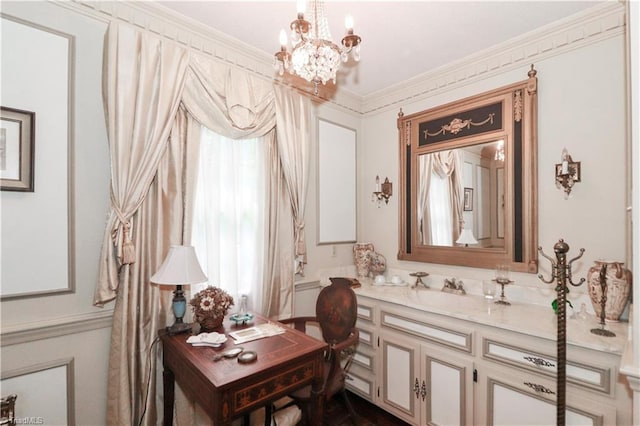 bathroom with ornamental molding, vanity, and a chandelier