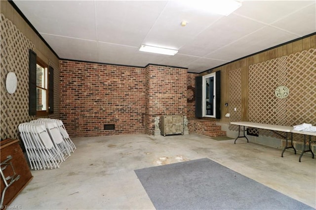 finished below grade area featuring brick wall