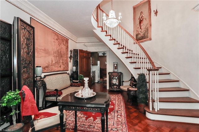 interior space featuring ornamental molding, stairway, and an inviting chandelier