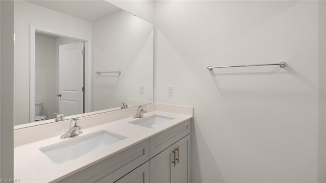 bathroom featuring vanity and toilet