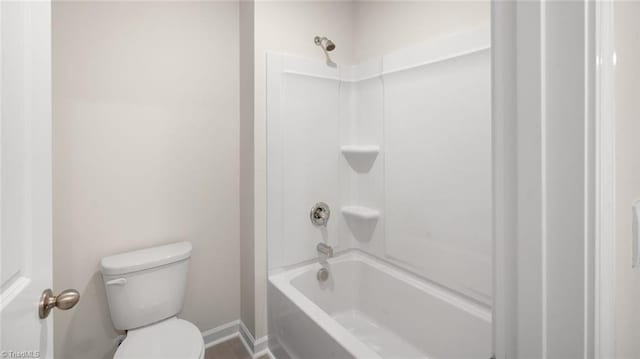 bathroom with washtub / shower combination and toilet