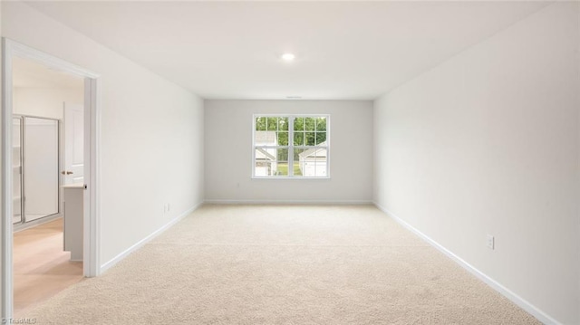 spare room with light colored carpet