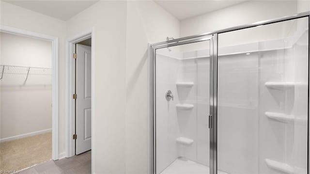319 Willowbrooke Way, Stokesdale, NC 27357 - full bathroom with a shower stall, a spacious closet, and baseboards