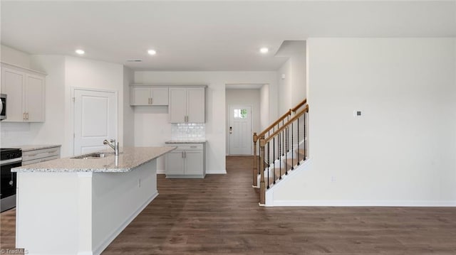 319 Willowbrooke Way, Stokesdale, NC 27357 - kitchen featuring a sink, backsplash, dark wood-type flooring, a kitchen island with sink, and stainless steel appliances