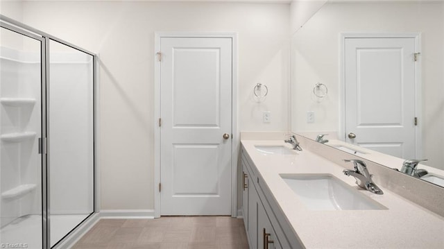 319 Willowbrooke Way, Stokesdale, NC 27357 - bathroom with double vanity, a stall shower, tile patterned floors, and baseboards