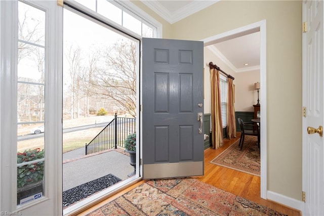 entrance foyer featuring crown molding and light wood-type flooring